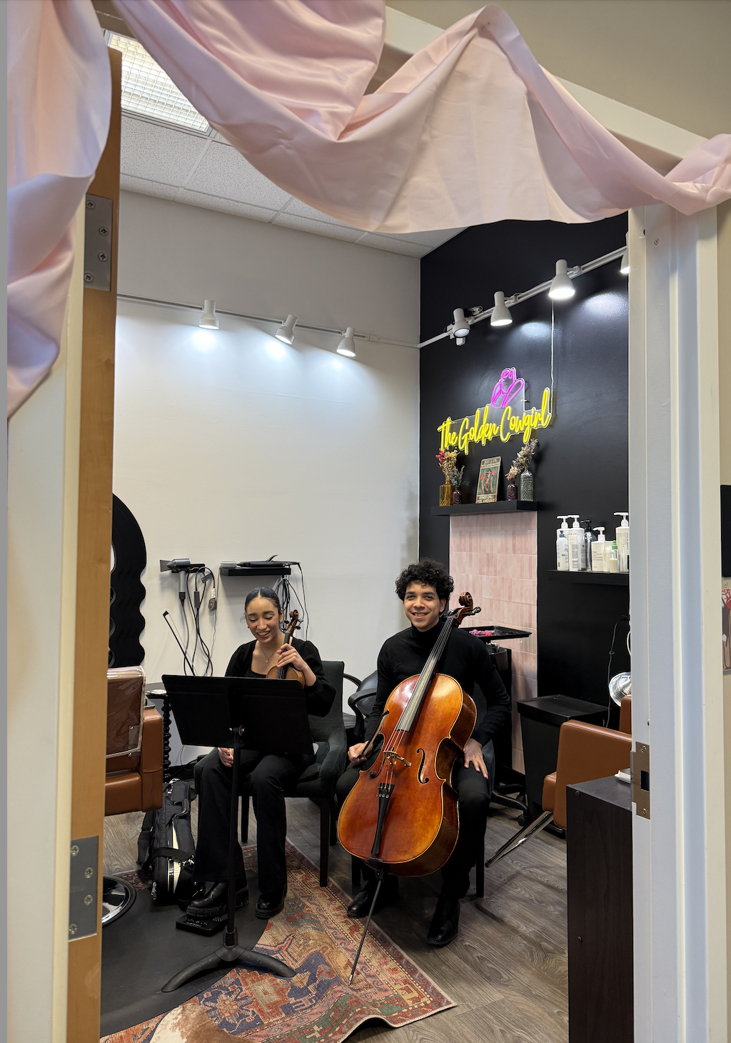 A live cello duet performing inside the Good Anatomy suite.